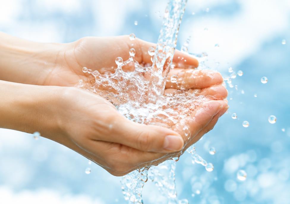 Hands catching a splash of clean water